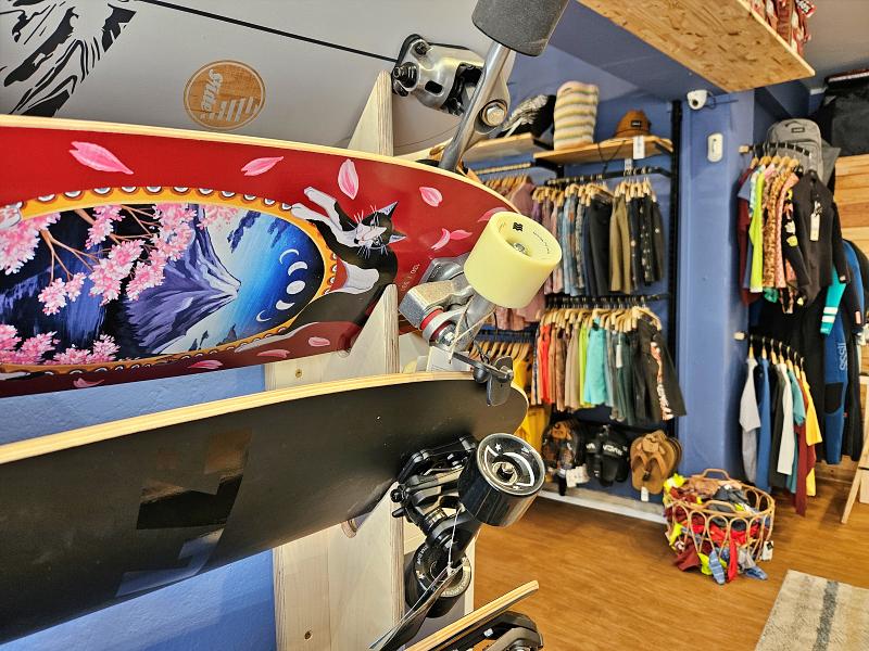 surf skate board that is sitting on a rack in a room