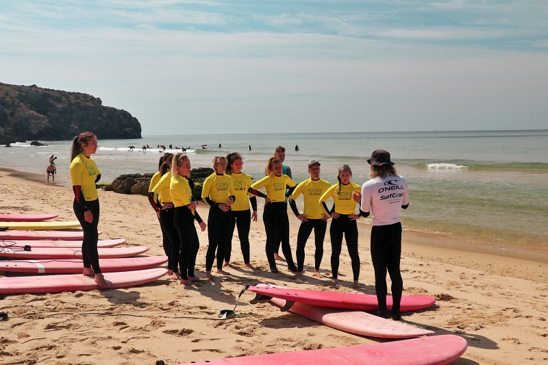 A group of surfers about to hit the waves
