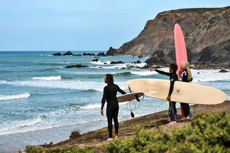 People looking out into the ocean for surf
